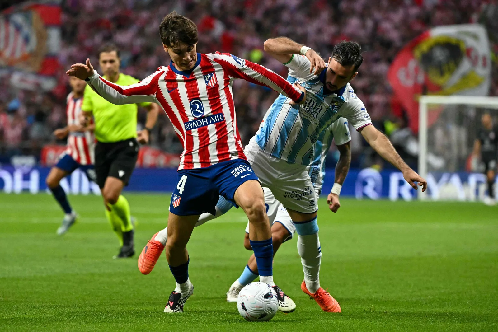 #04 Rodrigo Mendoza (L) is challenged by Malaga's Spanish defender #03 Carlos Puga.